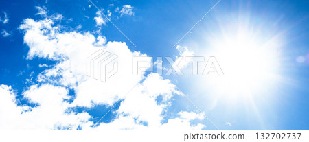 A simple landscape of blue sky, clouds and sun 132702737