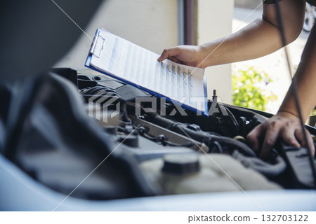 Close up Man hands fixing Car machinery vehicle mechanical service. Mechanic man hands repairing car auto repair shop. open vehicle hood checking up auto mobile. Vehicle Car maintenance engineer. 132703122