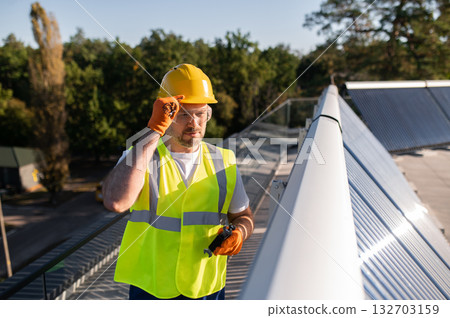 Technician maintaining photovoltaic equipment Technician maintaining photovoltaic equipment 132703159