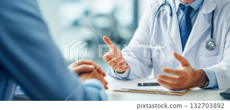 Medical professional discusses health concerns with a patient in a clinical setting 132703892
