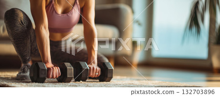 Home workout session with dumbbells for building strength and fitness 132703896