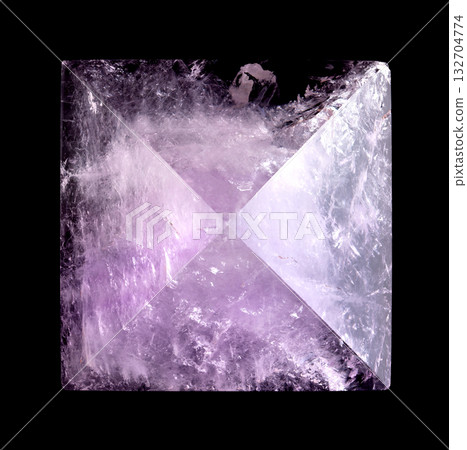 Amethyst pyramid, close-up, from above, isolated, on black background. Cut and polished semi-precious stone, with exact apex, 5 cm base length, and a height of 3.5 cm. Violet variety of quartz, SiO2. Amethyst pyramid, close-up, from above, isolated, on black background. Cut and polished semi-precious stone, with exact apex, 5 cm base length, and a height of 3.5 cm. Violet variety of quartz, SiO2. 132704774