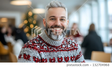 Joyful man in festive sweater smiles during holiday celebration in cozy indoor setting Joyful man in festive sweater smiles during holiday celebration in cozy indoor setting 132704968