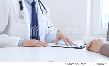 Adult doctor gesturing with hands while explaining diagnosis to patient during medical consultation in hospital office, healthcare and medical concept. Medicine concept 132706074