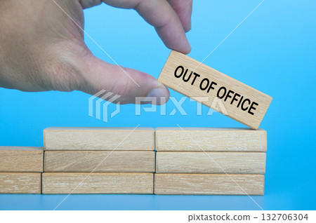 Hand putting wooden block with out of office text. Getaway or on a vacation concept. Hand putting wooden block with out of office text. Getaway or on a vacation concept. 132706304