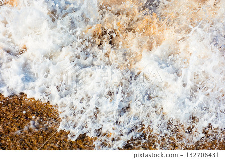 texture of sea foam on the sandy beach. scenic aqua splash. closeup natural abstract background on a sunny day. summer vacation season. frozen moment of salt water meets golden sand and make art mess texture of sea foam on the sandy beach. scenic aqua splash. closeup natural abstract background on a sunny day. summer vacation season. frozen moment of salt water meets golden sand and make art mess 132706431