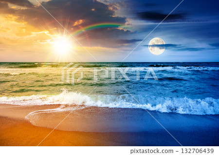 sea waves crashing sandy beach. day and night time change concept. summer solstice on a windy weather under cloudy sky with sun and moon. view of dramatic seascape. duality and transition template sea waves crashing sandy beach. day and night time change concept. summer solstice on a windy weather under cloudy sky with sun and moon. view of dramatic seascape. duality and transition template 132706439