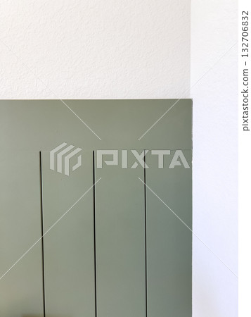 Bold green accent wall panels with a matte finish, part of a modern bedroom design. Useful for paint color inspiration or interior styling visuals. 132706832