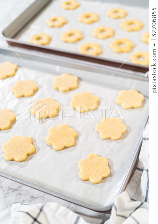 Alternating layers of top and bottom flower sugar cookies prepared for Easter Cookie Sandwich with Raspberry Buttercream. These cookies bake to soft perfection. 132706855