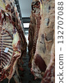 Industrial slaughterhouse scene description, Chill room with hanging beef carcasses and shadows 132707088