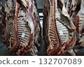 Industrial slaughterhouse scene description, Chill room with hanging beef carcasses and shadows 132707089
