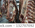Industrial slaughterhouse scene description, Chill room with hanging beef carcasses and shadows 132707092