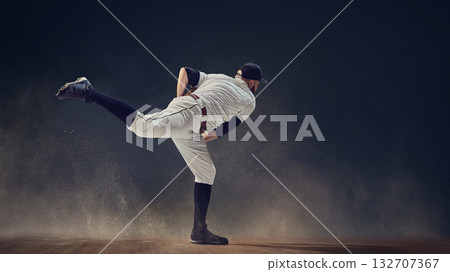 Baseball pitcher completing throw follow-through with dust swirling around showing momentum release 132707367