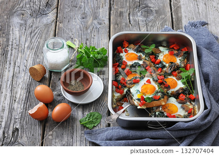 baked eggs with spinach, mushroom, sweet pepper 132707404