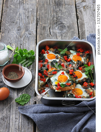 baked eggs with spinach, mushroom, sweet pepper 132707405