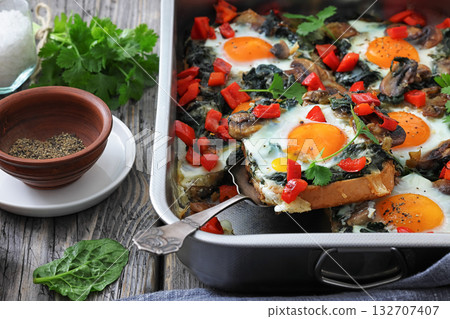 baked eggs with spinach, mushroom, sweet pepper 132707407