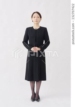 Portrait of a woman in mourning clothes, looking at camera, white background, full body Portrait of a woman in mourning clothes, looking at camera, white background, full body 132707422