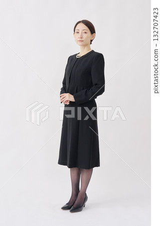 Portrait of a woman in mourning clothes, looking at camera, white background, full body Portrait of a woman in mourning clothes, looking at camera, white background, full body 132707423