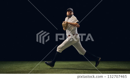 Baseball pitcher mid-stride transition phase before throw showing ground reaction control 132707465