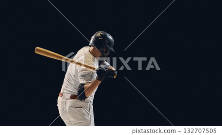 Baseball batter lowering bat before swing showing pre-impact shoulder control 132707505