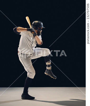 Baseball player lifting front leg preparing for swing during hitting drill Baseball player lifting front leg preparing for swing during hitting drill 132707506