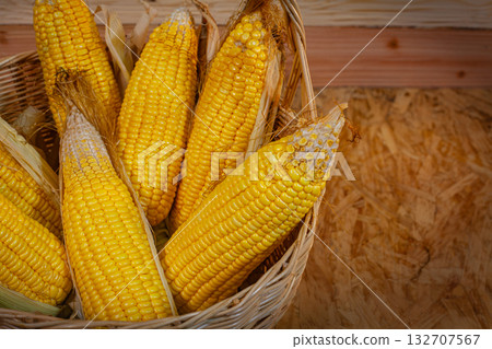 Bright Golden Corn Neatly Placed in a Handcrafted Rattan Basket Bright Golden Corn Neatly Placed in a Handcrafted Rattan Basket 132707567