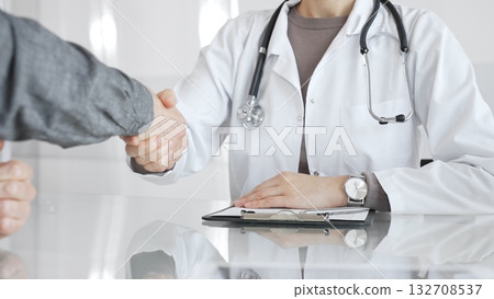 Doctor and patient hands shaking, symbolizing trust, agreement, healthcare partnership, successful consultation, and medical service. Medicine and health care Doctor and patient hands shaking, symbolizing trust, agreement, healthcare partnership, successful consultation, and medical service. Medicine and health care 132708537