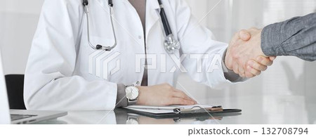 Doctor and patient hands shaking, symbolizing trust, agreement, healthcare partnership, successful consultation, and medical service. Medicine and health care 132708794