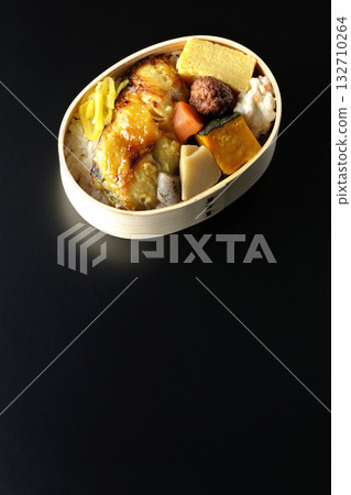 Grilled fish bento photographed against a black background Grilled fish bento photographed against a black background 132710264