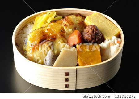 Grilled fish bento photographed against a black background 132710272