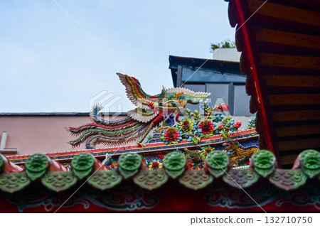Close-up of the ornate decor on the Mengjia Longshan Temple in Taipei, Taiwan. Chinese folk religion landmark. Buddhist Temple. Religious and traditional Chinese art. Close-up of the ornate decor on the Mengjia Longshan Temple in Taipei, Taiwan. Chinese folk religion landmark. Buddhist Temple. Religious and traditional Chinese art. 132710750