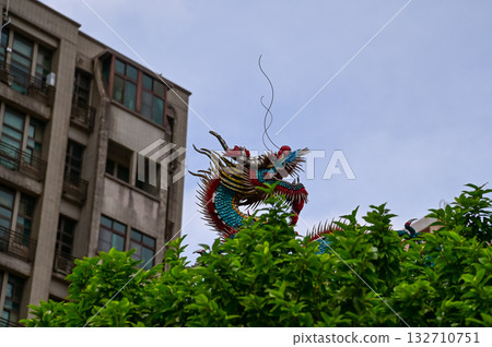 Close-up of the ornate decor on the Mengjia Longshan Temple in Taipei, Taiwan. Chinese folk religion landmark. Buddhist Temple. Religious and traditional Chinese art. Close-up of the ornate decor on the Mengjia Longshan Temple in Taipei, Taiwan. Chinese folk religion landmark. Buddhist Temple. Religious and traditional Chinese art. 132710751