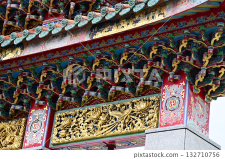 Close-up of the ornate decor on the Mengjia Longshan Temple in Taipei, Taiwan. Chinese folk religion landmark. Buddhist Temple. Religious and traditional Chinese art.  132710756