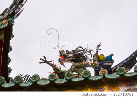Close-up of the ornate decor on the Mengjia Longshan Temple in Taipei, Taiwan. Chinese folk religion landmark. Buddhist Temple. Religious and traditional Chinese art. Close-up of the ornate decor on the Mengjia Longshan Temple in Taipei, Taiwan. Chinese folk religion landmark. Buddhist Temple. Religious and traditional Chinese art. 132710761