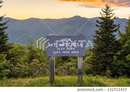 Car road trip on Blue Ridge Parkway in North Carolina Appalachian mountains. Mt Mitchell Overlook in summer season at sunset. Summertime landscape of beautiful nature Car road trip on Blue Ridge Parkway in North Carolina Appalachian mountains. Mt Mitchell Overlook in summer season at sunset. Summertime landscape of beautiful nature 132711437