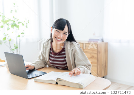 Young woman studying at home 132711473
