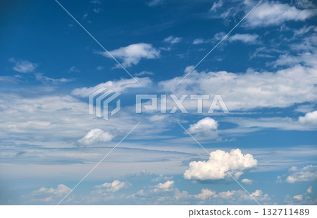 Bright landscape of white puffy cumulus clouds on blue clear sky. Bright landscape of white puffy cumulus clouds on blue clear sky. 132711489