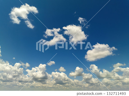 Bright landscape of blue sky with flying white clouds. Colorful summer skyscape Bright landscape of blue sky with flying white clouds. Colorful summer skyscape 132711493