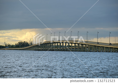 Barron Collier Bridge and Gilchrist Bridge in Florida with moving traffic. Transportation infrastructure in Charlotte County connecting Punta Gorda and Port Charlotte over Peace River Barron Collier Bridge and Gilchrist Bridge in Florida with moving traffic. Transportation infrastructure in Charlotte County connecting Punta Gorda and Port Charlotte over Peace River 132711523