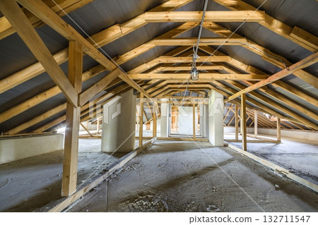 Attic of a building with wooden beams of a roof structure. Attic of a building with wooden beams of a roof structure. 132711547
