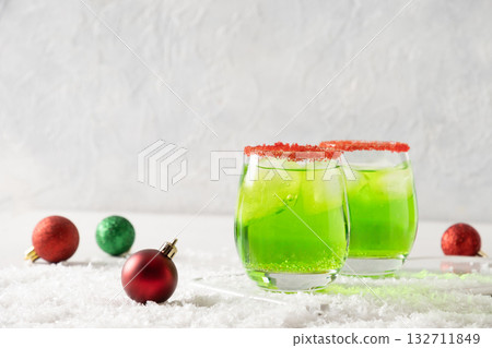 Xmas Green Punch Cocktails decorated sugar rim on white make of cool lime sherbet. Tasty drink for Christmas holiday. Rim your festive beverages in red sugar. Xmas Green Punch Cocktails decorated sugar rim on white make of cool lime sherbet. Tasty drink for Christmas holiday. Rim your festive beverages in red sugar. 132711849