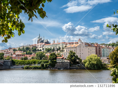 Prague, Czech Republic, August 8, 2023. A postcard view of the city: the castle on the hill is framed by trees and the river. A beautiful summer day. Travel destinations. 132711896