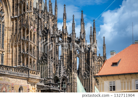 Prague, Czech Republic, August 8, 2023. Side detail of St. Vitus Cathedral, an example of Gothic architecture. A beautiful summer day. Travel destinations. 132711904