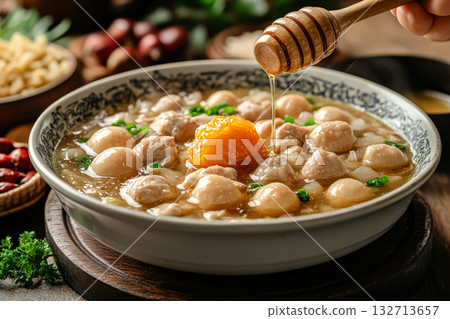 Bowl of food with a spoonful of honey on top 132713657