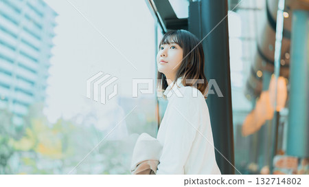Woman looking out the window Woman looking out the window 132714802
