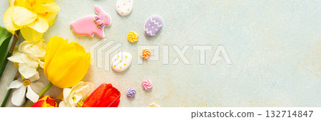Bright tulips and daffodils surround playful Easter cookies and candies, showcasing the vibrant spirit of springtime festivities and holiday celebrations, banner Bright tulips and daffodils surround playful Easter cookies and candies, showcasing the vibrant spirit of springtime festivities and holiday celebrations, banner 132714847