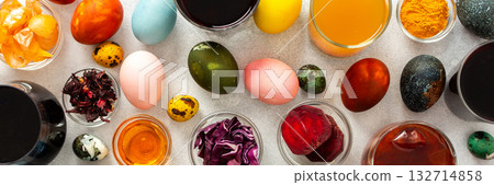 Colorful Easter eggs surround various bowls filled with natural dyes such as beets, turmeric and flower extracts hibiscus, red cabbage and onion peel, showcasing a creative egg decorating process Colorful Easter eggs surround various bowls filled with natural dyes such as beets, turmeric and flower extracts hibiscus, red cabbage and onion peel, showcasing a creative egg decorating process 132714858