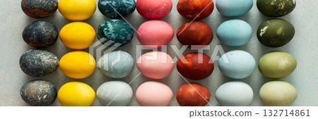 A beautiful array of hand-dyed Easter eggs in various colors, neatly arranged in rows. This colorful display celebrates the spring season and Easter traditions with creativity, banner A beautiful array of hand-dyed Easter eggs in various colors, neatly arranged in rows. This colorful display celebrates the spring season and Easter traditions with creativity, banner 132714861