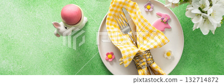 A vibrant Easter table setting features yellow checkered napkins wrapped with twine, a decorative plate, and fresh flowers, creating a festive atmosphere for spring gatherings, banner A vibrant Easter table setting features yellow checkered napkins wrapped with twine, a decorative plate, and fresh flowers, creating a festive atmosphere for spring gatherings, banner 132714872