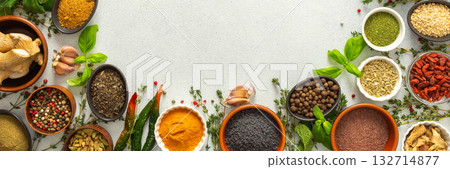 Colorful, fresh herbs and spices framing a gray background, a perfect natural border to bring attention to culinary creativity, top view and copy space, banner 132714877